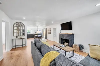 a living room with a couch and a fireplace at Main Street Retreat in Roseville
