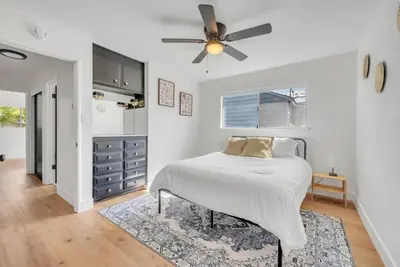 a bedroom with a bed and a ceiling fan at Main Street Retreat in Roseville