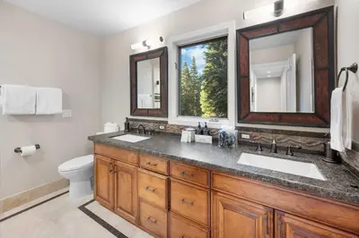 a bathroom with a sink and a toilet and a mirror at Luxury Tahoe Vacation Rental with HotTub & Lake Views in Tahoe Vista