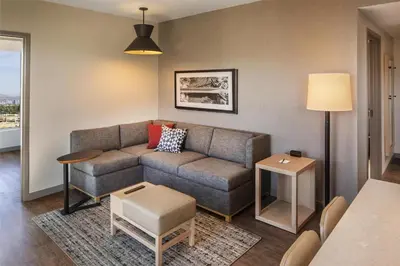 a living room with a couch and a table at Hyatt Place Reno in Reno