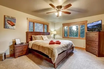 a bedroom with a bed and a ceiling fan at On Tahoe Time - Pets Pool Table Game Room in South Lake Tahoe