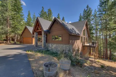 a wooden house with trees in the background at On Tahoe Time - Pets Pool Table Game Room in South Lake Tahoe