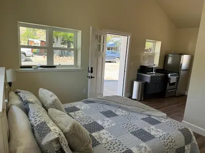 a bedroom with a bed with a checkered blanket at Ambrosia Hour on the Markleeville River in Markleeville
