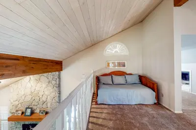 a bedroom in a house with a bed in the attic at Windwood Inn in Shaver Lake