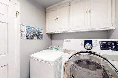 a white laundry room with a washer and dryer at Windwood Inn in Shaver Lake