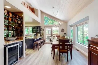 a kitchen and dining room with a table and chairs at Windwood Inn in Shaver Lake