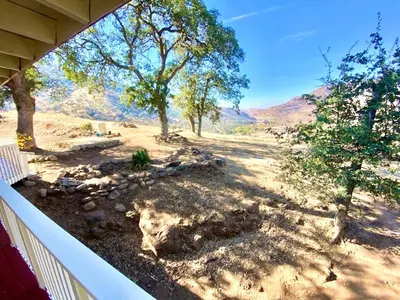 a view of a yard with trees and a fence at Spacious sequoia Park retreat, best panoramic views in Three Rivers