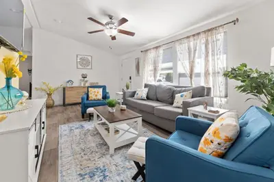 a living room with blue chairs and a couch at Minutes from Sequoia Entrance in Three Rivers