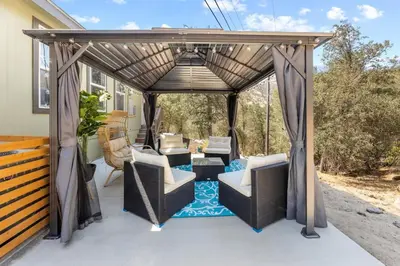 a gazebo with chairs and tables on a patio at Minutes from Sequoia Entrance in Three Rivers