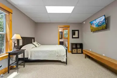 a bedroom with a bed and a bench in it at Sierra Haus Cottage with Private Lake Access in Sonora