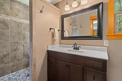 a bathroom with a sink and a mirror at Sierra Haus Cottage with Private Lake Access in Sonora