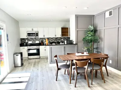 a kitchen and dining room with a wooden table and chairs at NEW cozy beautiful house with pool and hot tub in Fair Oaks