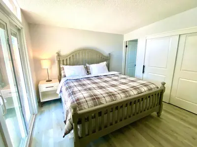 a bedroom with a bed with a plaid blanket at NEW cozy beautiful house with pool and hot tub in Fair Oaks