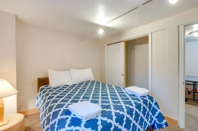 a bedroom with a blue and white bed with a window at Game Rooms, Sauna and Decks South Lake Tahoe Home in South Lake Tahoe