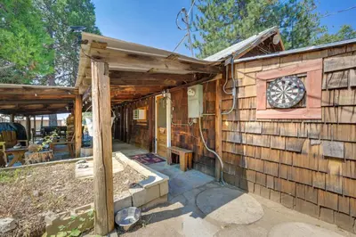 a cabin with a clock on the side of it at Rustic Cabin with Patio 8 Mi to Kings Canyon Park in Miramonte