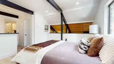 a bedroom with a large bed with a large window at Bigwood #96 condo in Mammoth Lakes