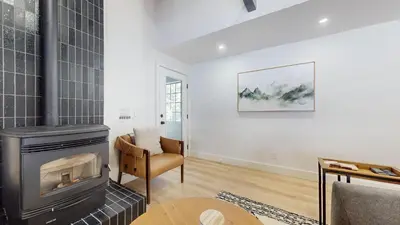 a living room with a fireplace and a chair at Bigwood #96 condo in Mammoth Lakes