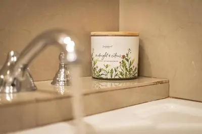 a candle sitting on a counter next to a sink at Adventure Awaits - Pets - Hot tub - Fire pit in Mevers