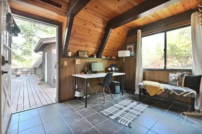 a home office with a desk and a large window at Hathaway Pines Hideaway Chalet in Hathaway Pines