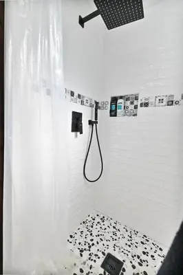 a bathroom with a shower with a shower curtain at Hathaway Hideaway Loft Apartment in Hathaway Pines