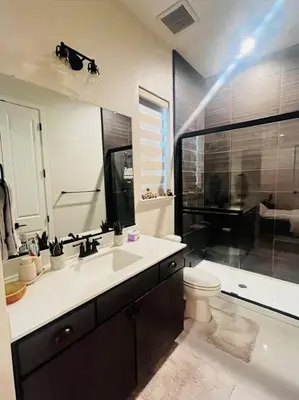 a bathroom with a sink and a toilet and a shower at Cozy Retreat facing Western Park in Tracy