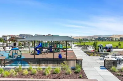 a playground at a park with a swing at Cozy Retreat facing Western Park in Tracy