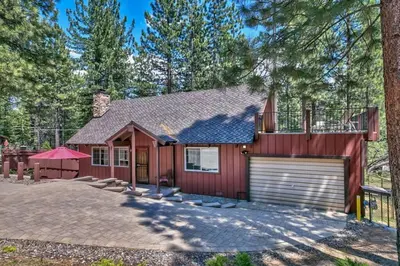 a red house with a garage at Tahoe Townie - Cozy Cabin in South Lake Tahoe! in South Lake Tahoe