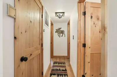 a hallway with wooden doors and a rug at Moose Haven - Family Favorite! Close to beaches! in South Lake Tahoe