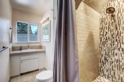 a bathroom with a shower and a toilet and a sink at Panorama Chalet - Hot tub - Pool Table - Snow in Nebelhorn