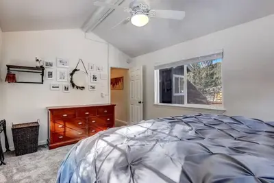 a bedroom with a bed and a window and a dresser at Panorama Chalet - Hot tub - Pool Table - Snow in Nebelhorn