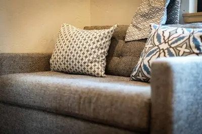 a couch with pillows on top of it at Mountain Pine Memories - Dogs - Hot tub - E-bikes in South Lake Tahoe