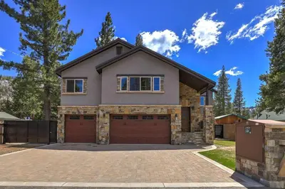 a house with a brick driveway and a garage at Chateau de Navahoe - Luxury - Hot tub - Large yard in South Lake Tahoe