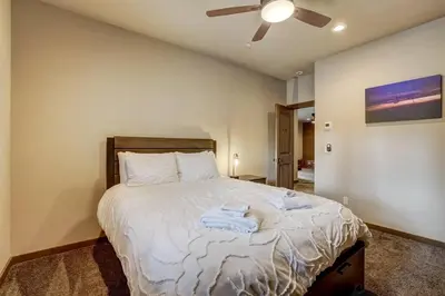 a bedroom with a large bed with a ceiling fan at Chateau de Navahoe - Luxury - Hot tub - Large yard in South Lake Tahoe