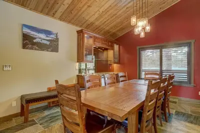 a dining room with a wooden table and chairs at Chateau de Navahoe - Luxury - Hot tub - Large yard in South Lake Tahoe