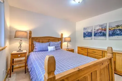a bedroom with a wooden bed and two lamps at Tahoe Tranquility - Dogs - Hot tub - Ping Pong in South Lake Tahoe