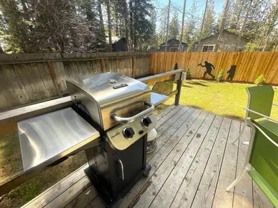 a grill sitting on top of a wooden deck at Bear Claw Trails - Dogs - Awesome Yard - Fire Pit in Lake Tahoe Airport