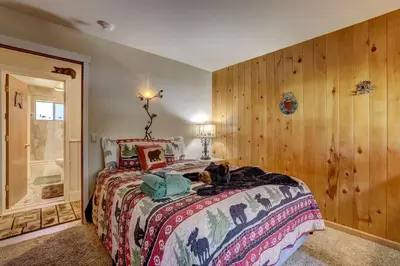 a bedroom with a bed with a dog laying on it at Bear Claw Trails - Dogs - Awesome Yard - Fire Pit in Lake Tahoe Airport