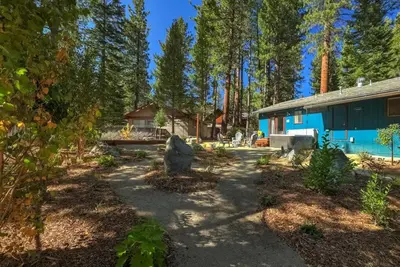a garden in front of a blue house at Guadalupe Getaway - Pets - Hot Tub - AC in South Lake Tahoe