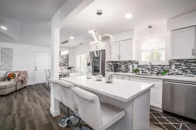 a kitchen with white cabinets and a large white island at Remodeled 1 Acre Ranch Home in Madera in Madera
