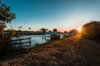 a sunset over a river with the sun setting at Waterfront Home w 40x16 Berth in Bethel Island