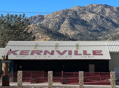 a sign on a building with mountains in the background at Mountain View Home in Kernville