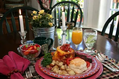 a table with a plate of food on a table at McCaffrey House Bed and Breakfast Inn in Twain Harte