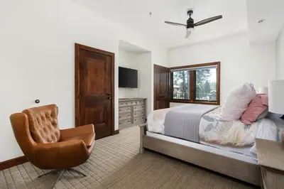a bedroom with a bed and a desk and a chair at Luxury 4BDR Residence steps from Heavenly Village condo in South Lake Tahoe
