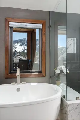 a bathroom with a tub and a window with a laptop at Luxury 4BDR Residence steps from Heavenly Village condo in South Lake Tahoe