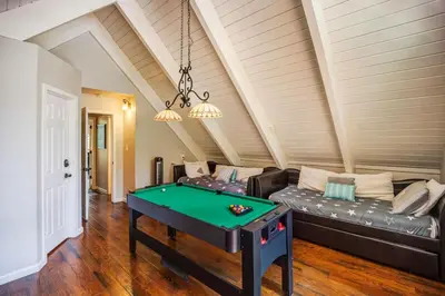 a living room with a pool table in it at Hot tub - Play structure - Mini pool table game in South Lake Tahoe