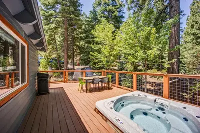 a hot tub on a deck with a table at Hot tub - Play structure - Mini pool table game in South Lake Tahoe