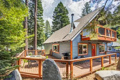 a tiny house in the woods with a deck at Hot tub - Play structure - Mini pool table game in South Lake Tahoe