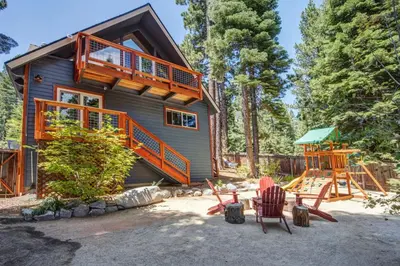 a house with a deck and a playground at Hot tub - Play structure - Mini pool table game in South Lake Tahoe