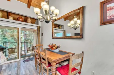 a dining room with a table and a mirror at Carnelian Bay 2BR + Loft Near Beach & Trails in Carnelian Bay