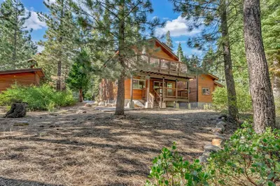 a log cabin in the woods with trees at Charming Tahoe Cabin with Private Beach Access in Tahoe City